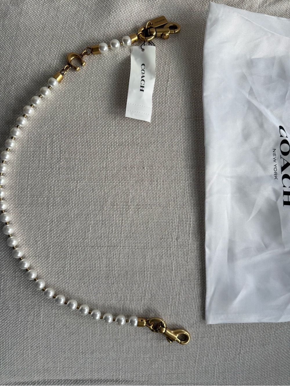 New w/ tags and bag Coach Pearl Strap or chain with Gold Hardware 19” stunning